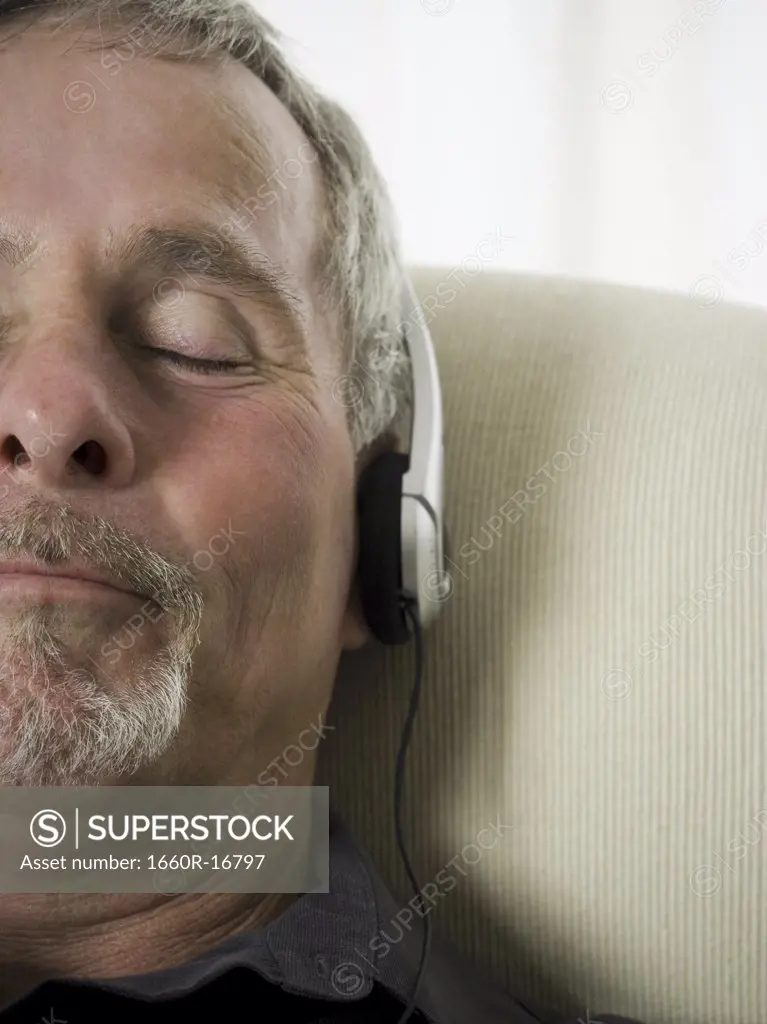 Close-up of a senior man listening to music