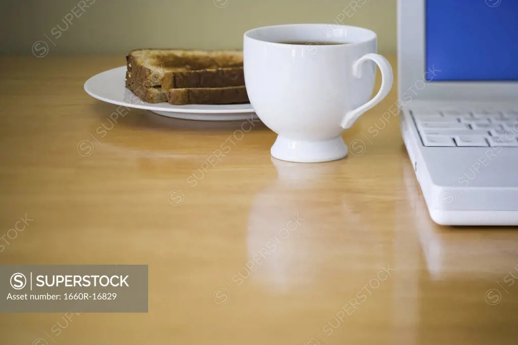 Close-up of laptop computer coffee and toast