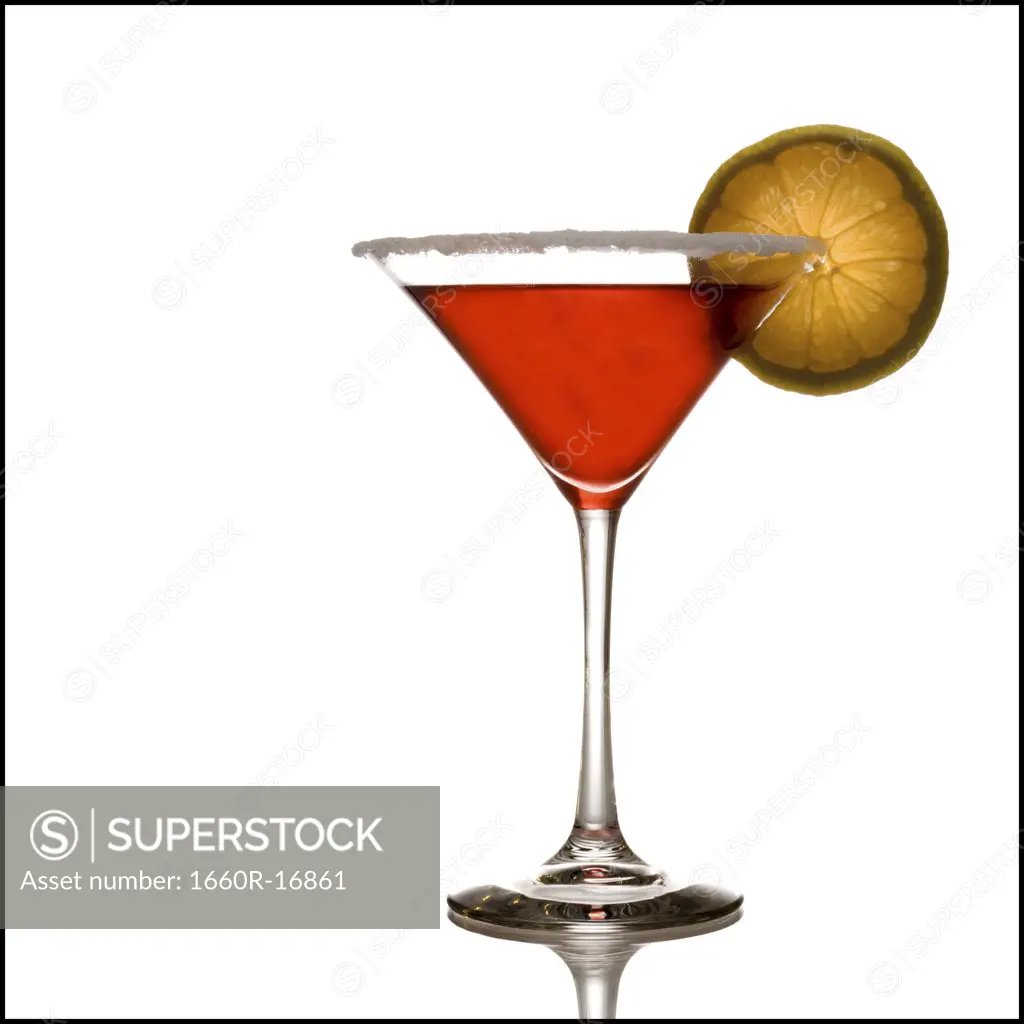 Red beverage in martini glass with lemon slice