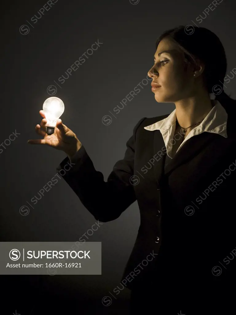 Profile of businesswoman with light bulb