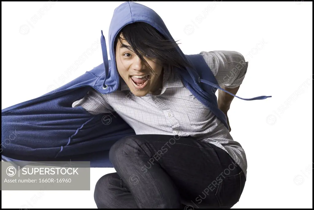 Man in hoodie dancing and smiling