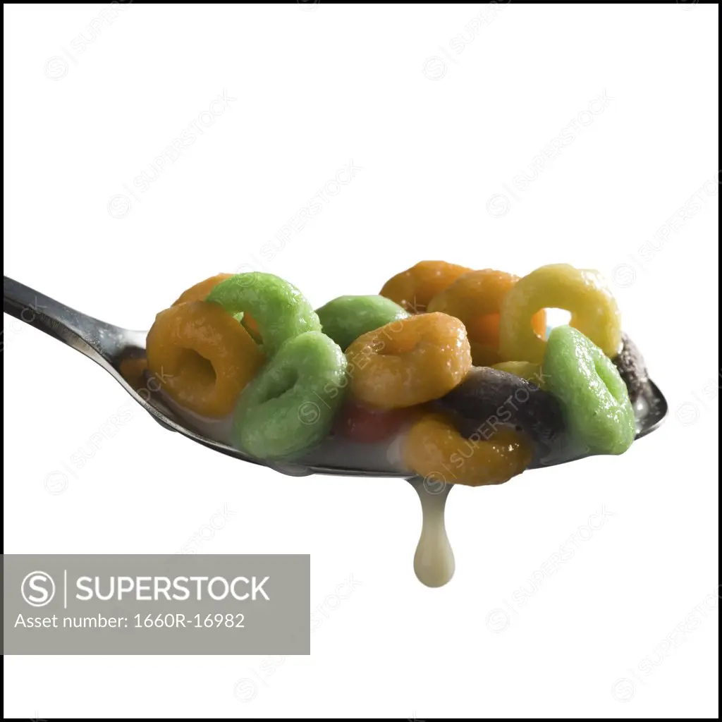 Detailed view of cereal on spoon with dripping milk