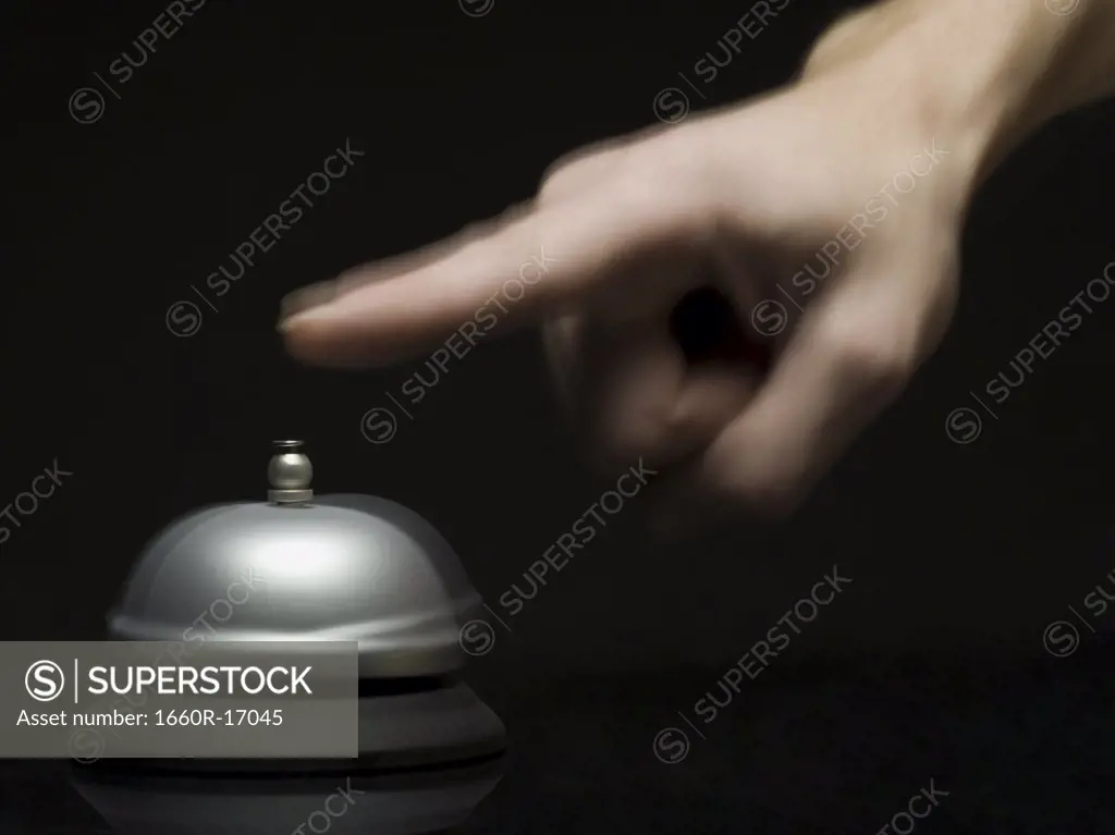 Woman's finger above bell