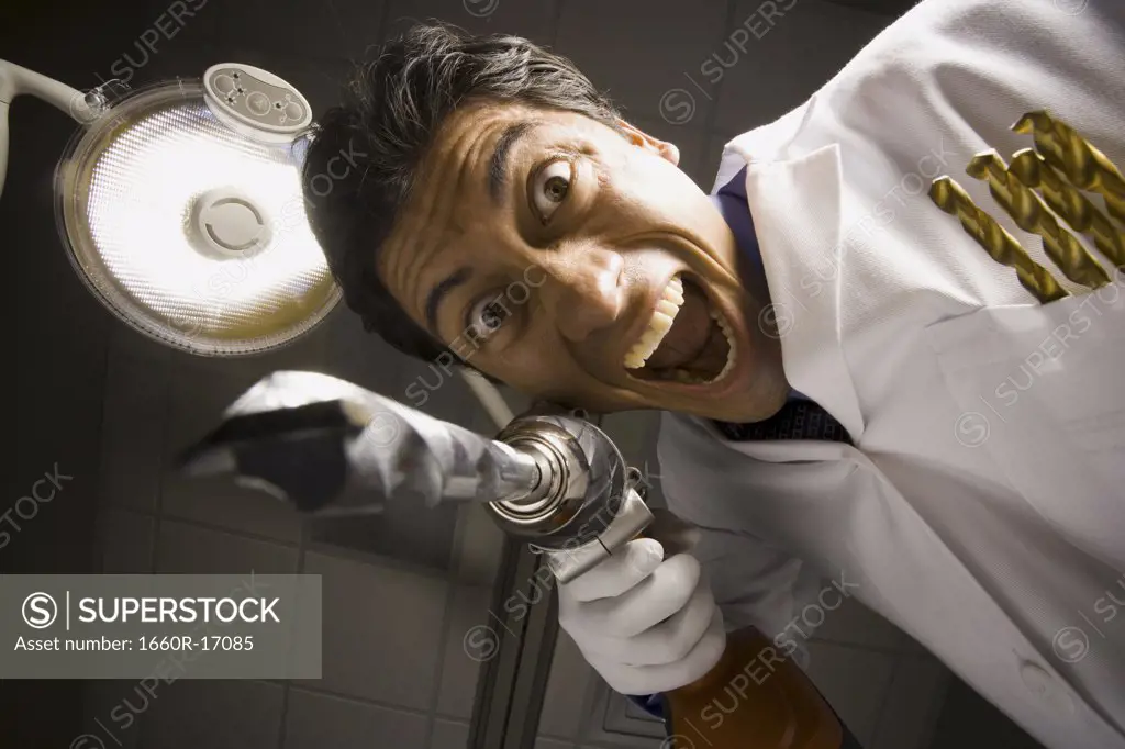 Dentist with drill dramatic angle