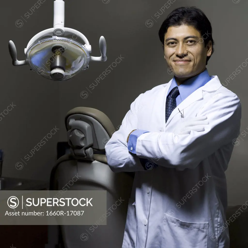 Dentist with arms crossed smiling