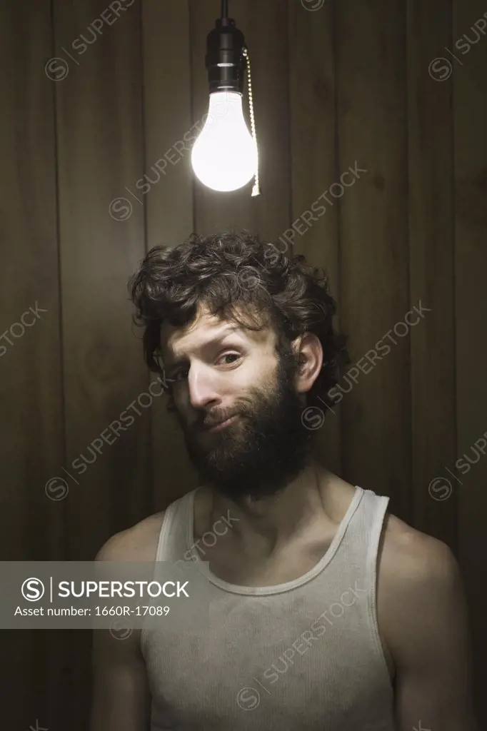 Man standing under light bulb