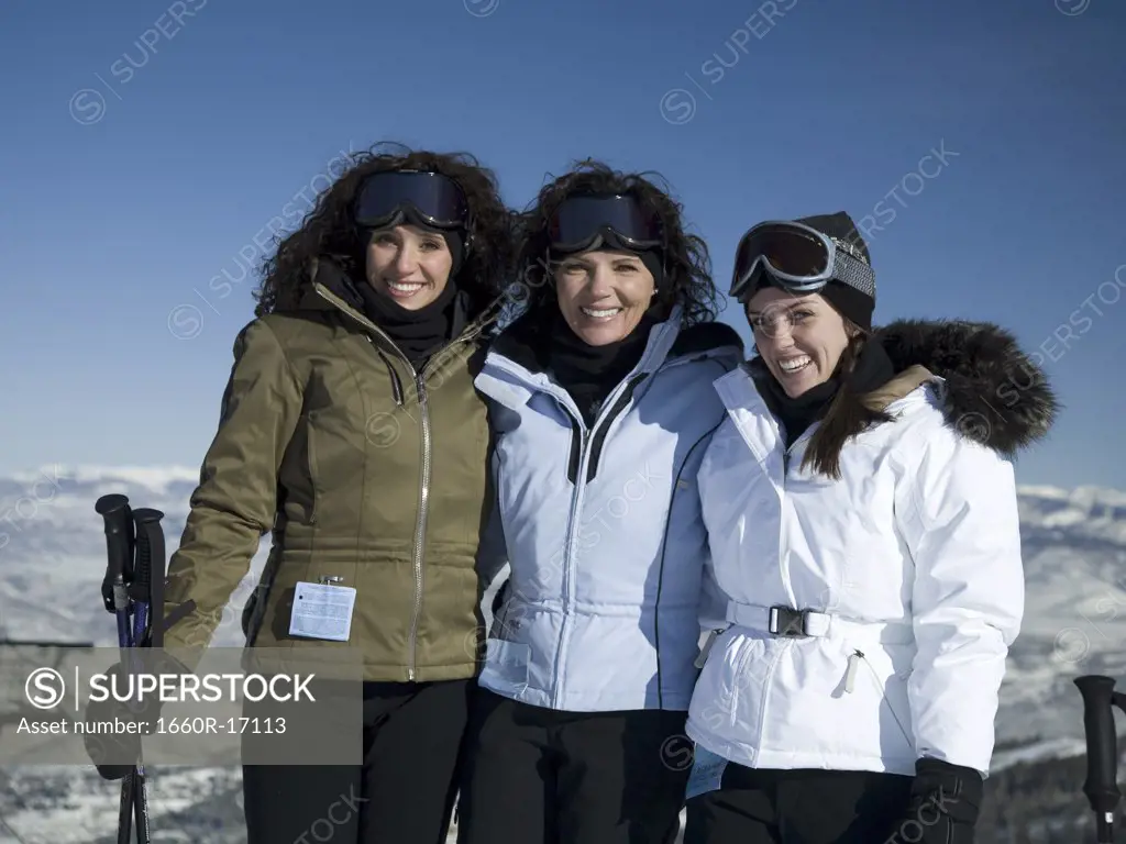 Three women outdoors in winter skiing