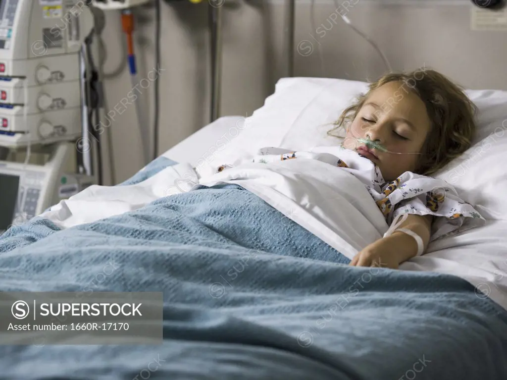 Young girl in hospital bed with respirator