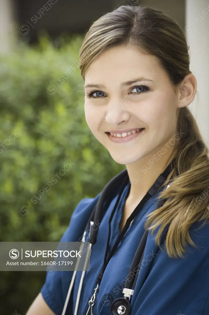 Female nurse outdoors smiling