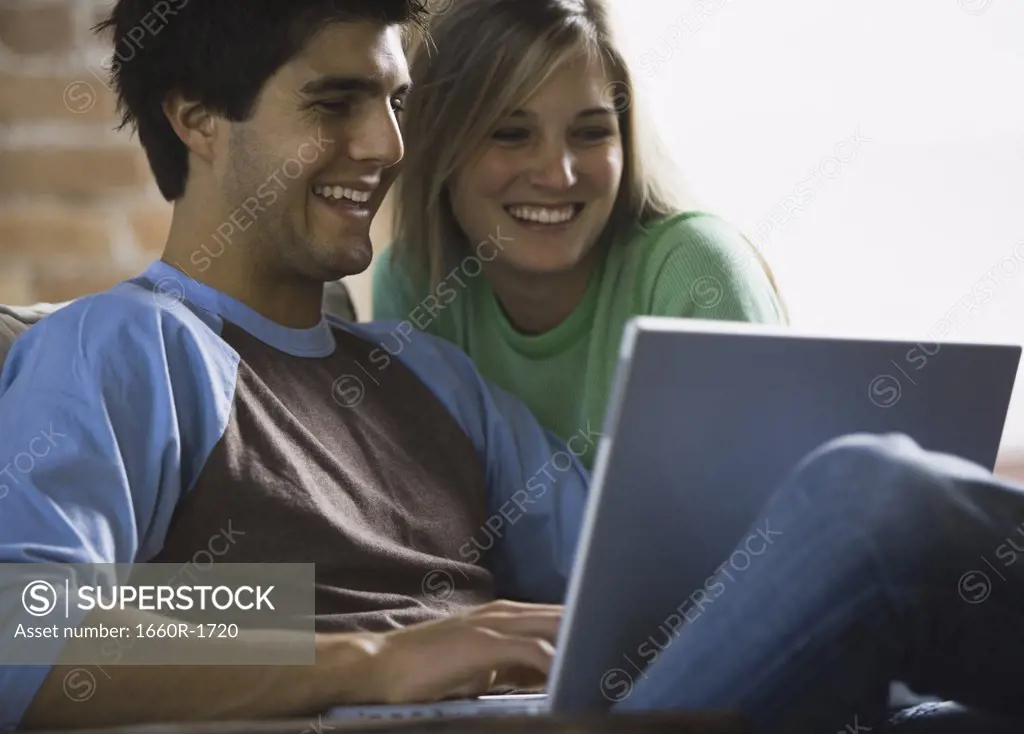 Close-up of a young couple working on a laptop