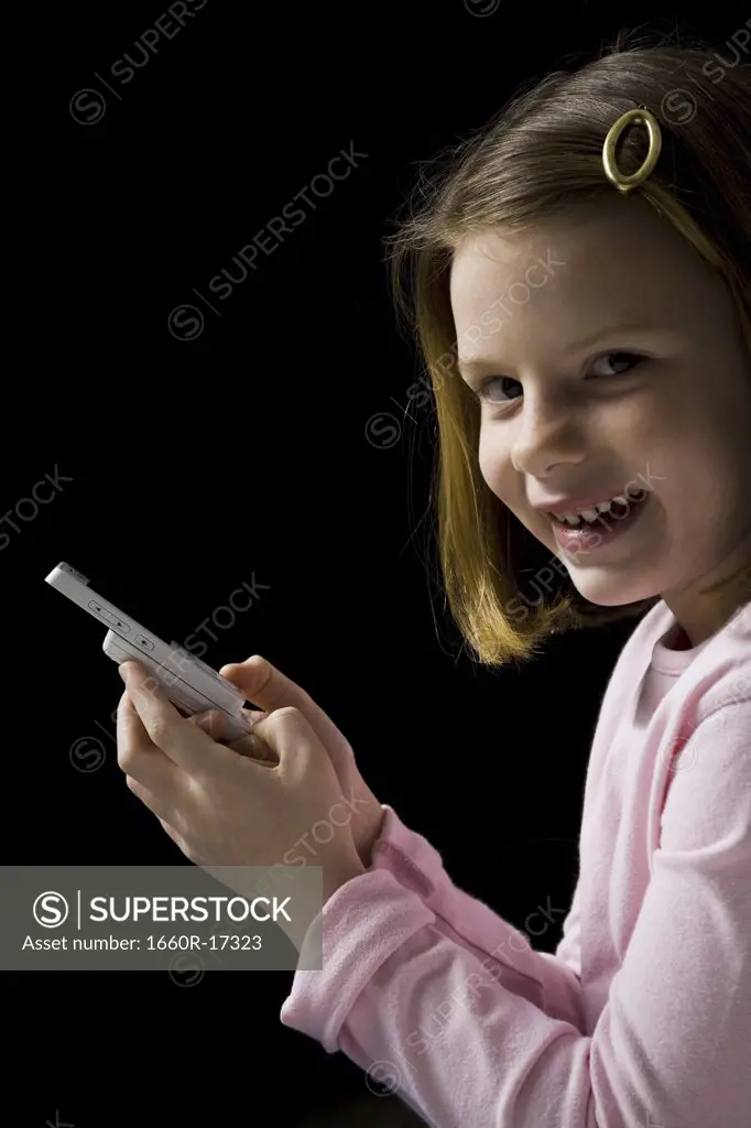 Young girl with cellular phone smiling