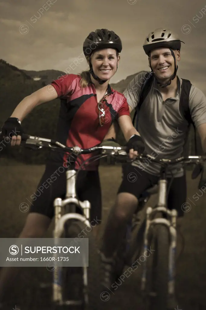 Portrait of a couple mountain biking