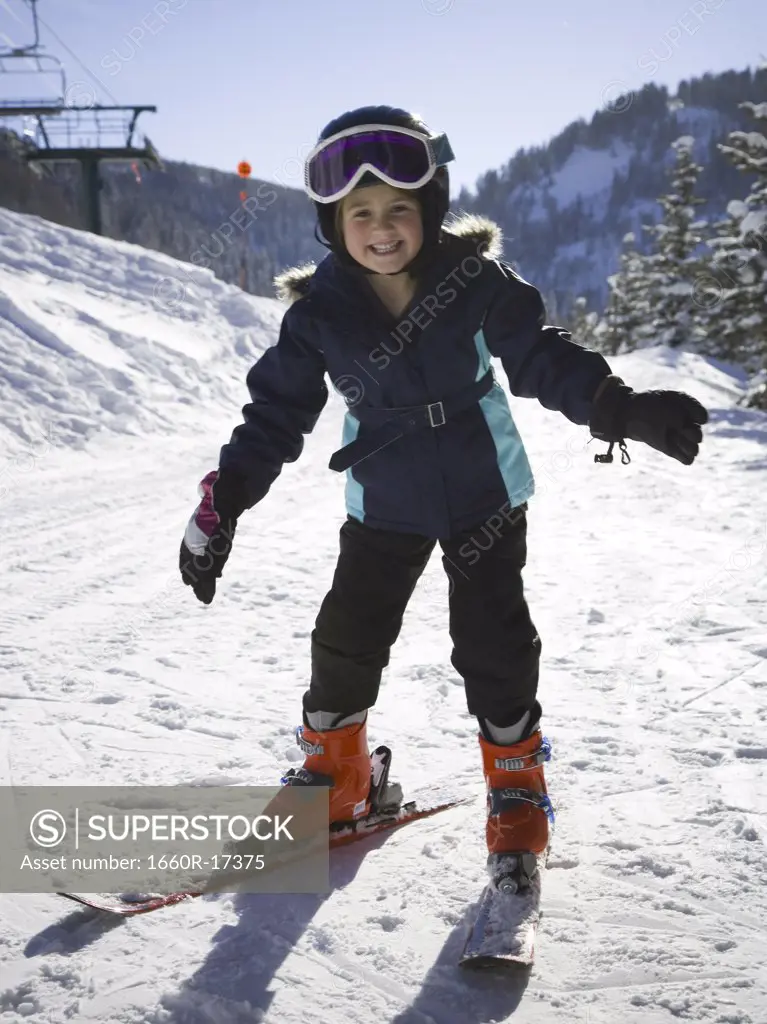 Young girl outdoors in winter with ski goggles