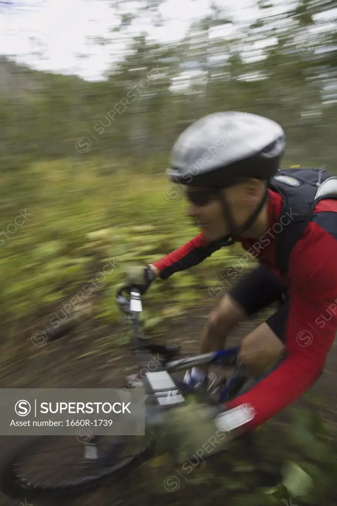 Profile of a mature man mountain biking