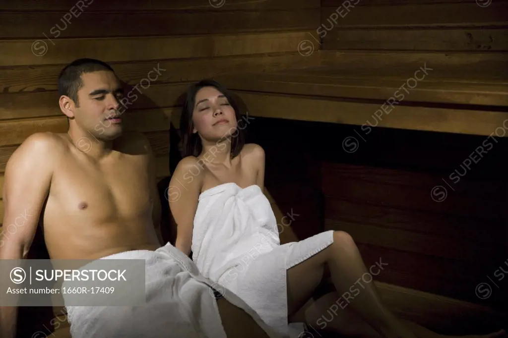 Man and woman in sauna relaxing