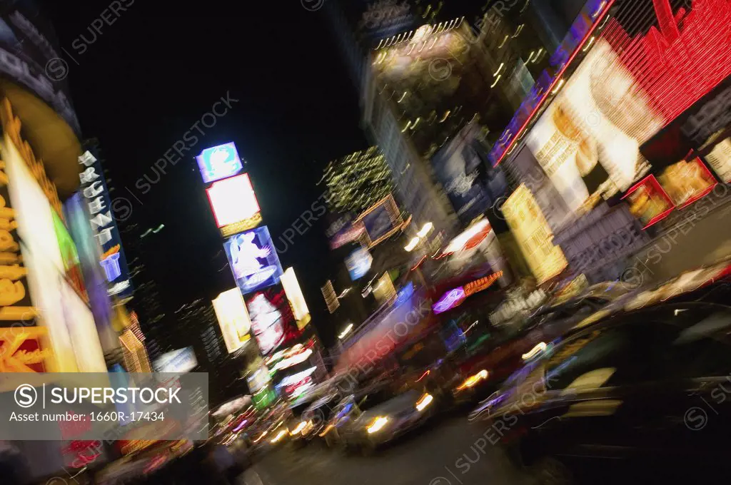 Downtown city at night with neon signs and motion blur