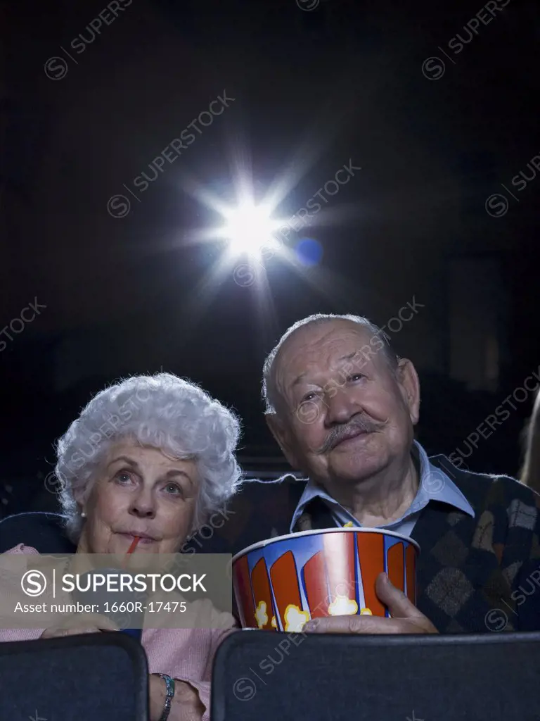 Man and woman watching movie with popcorn