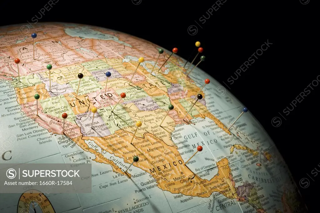 Closeup of pushpins in globe