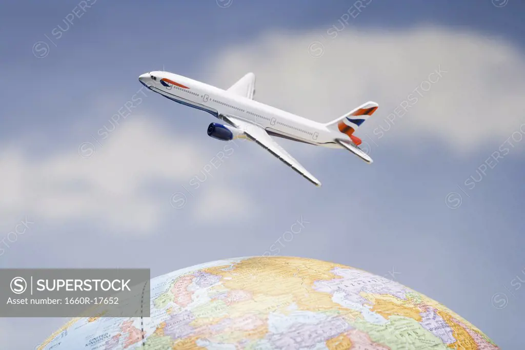 Airplane flying over globe with blue sky