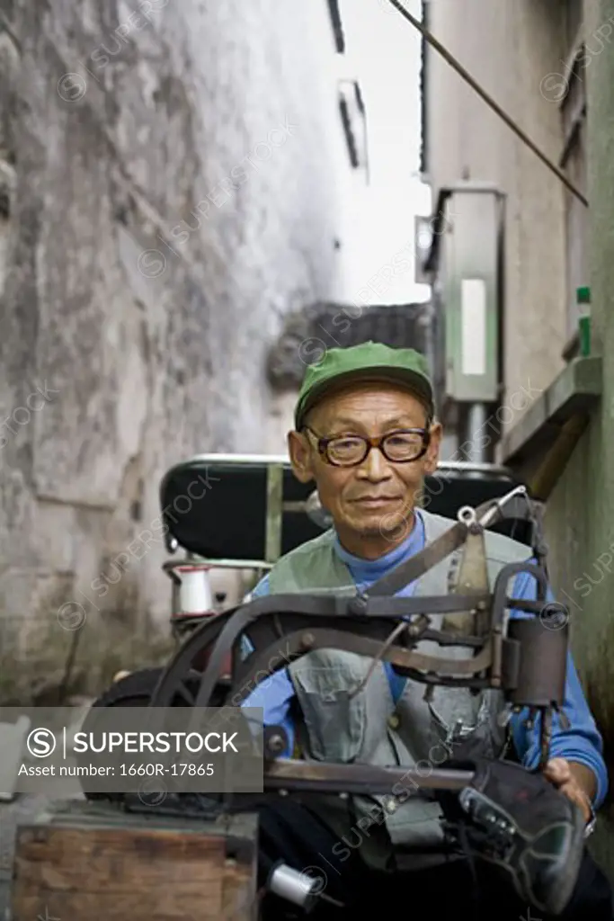 Man with eyeglasses outdoor with shoe machine