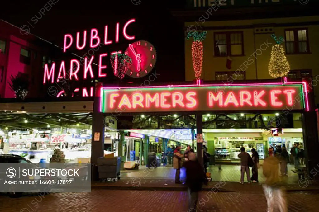 Farmers market neon sign at night in city