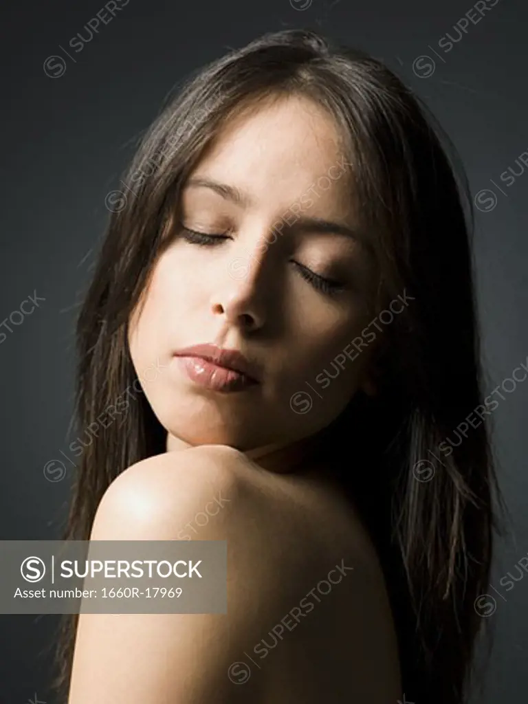 Portrait of a woman with bare shoulders and closed eyes