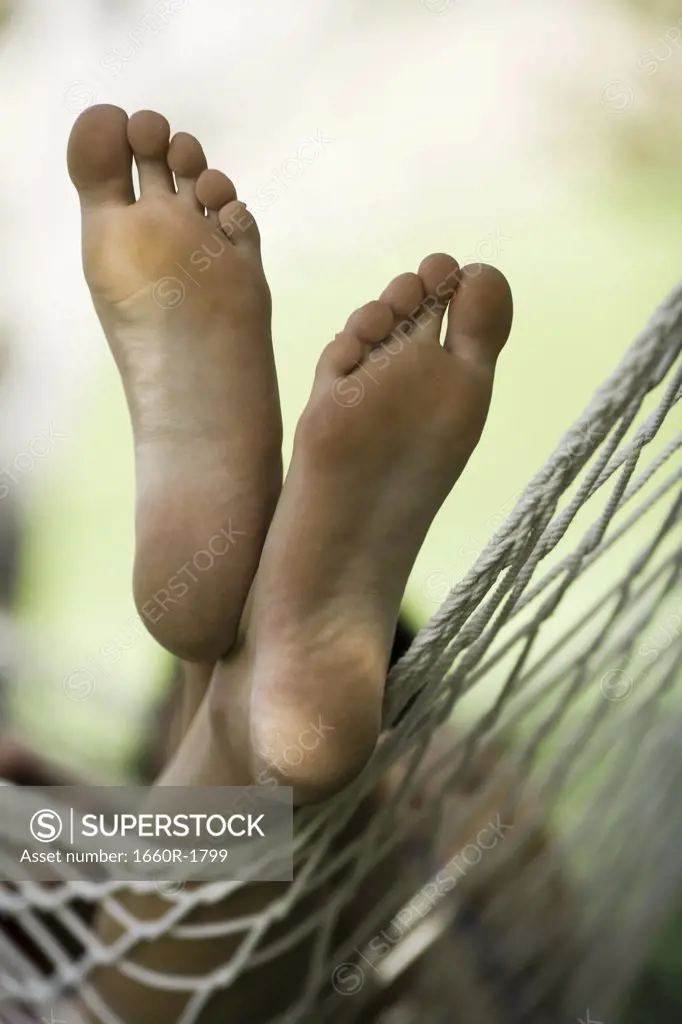 Close-up of a man's feet on a hammock