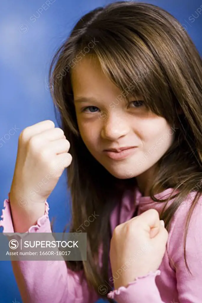 Girl with clenched fists smiling