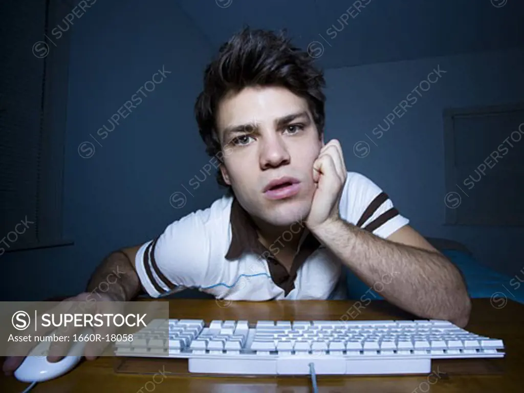 Man with hand on mouse and keyboard watching