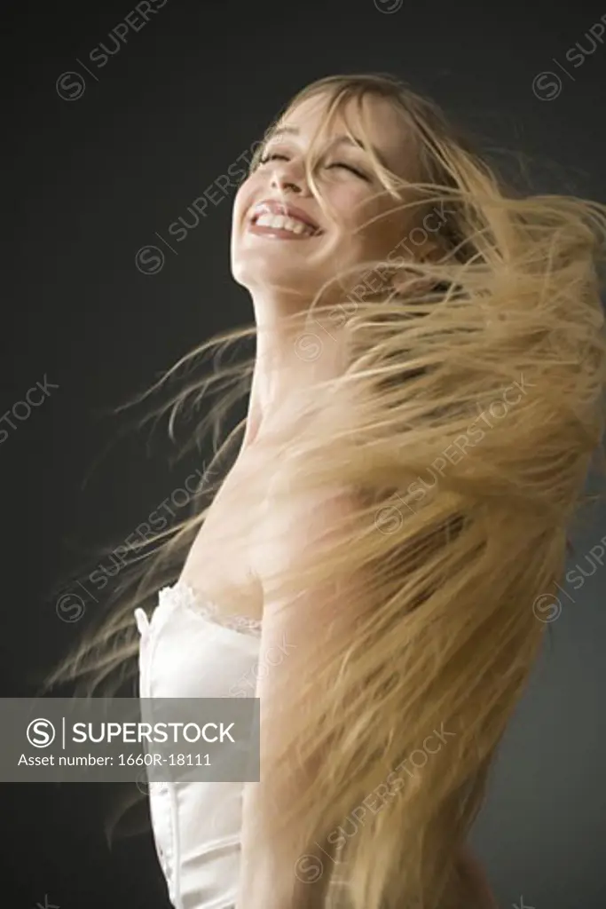 Woman with long blonde hair standing