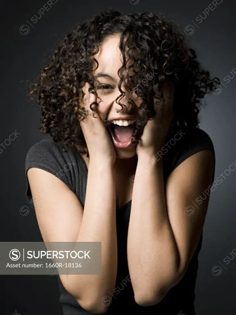 Woman with hands on face and mouth open