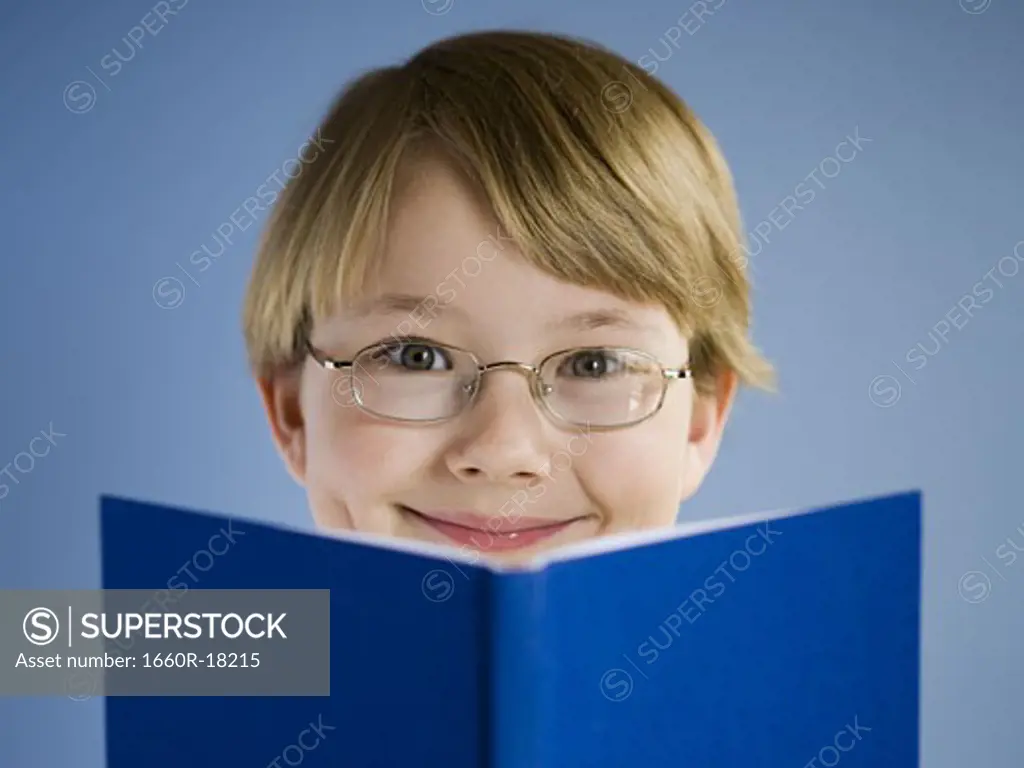 Boy reading book and smiling