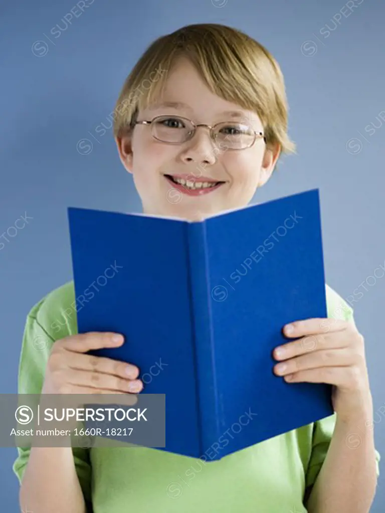 Boy reading book and smiling