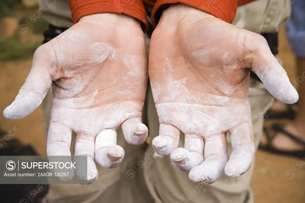 Detailed view of climbing chalk on male hands outdoors