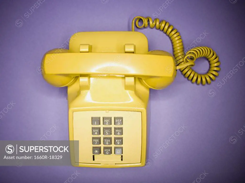 Overhead view of yellow retro phone