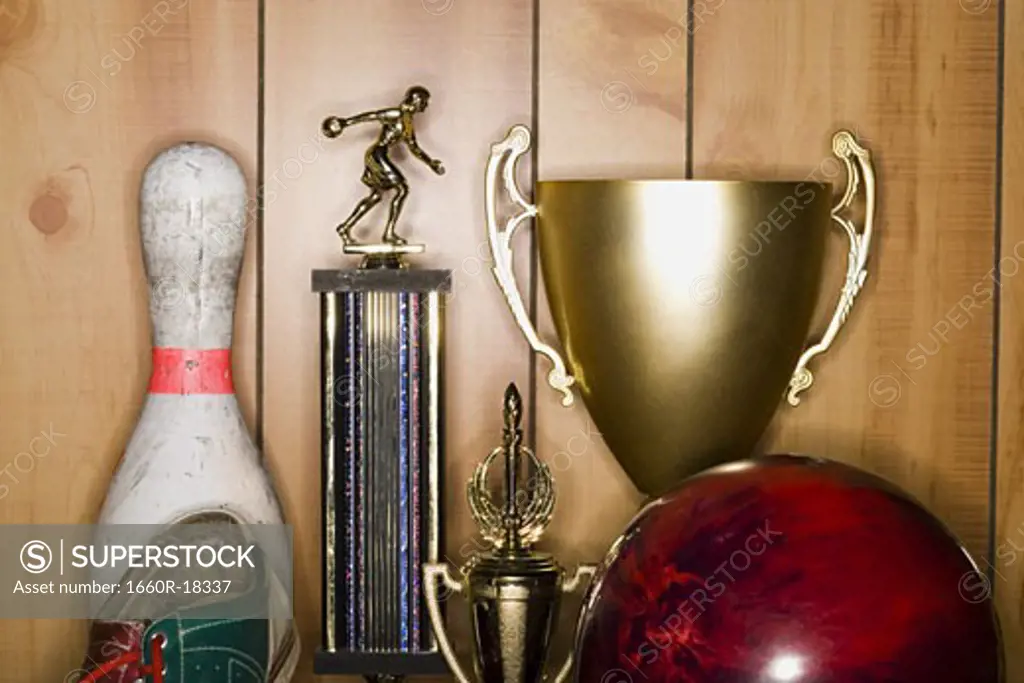 Bowling ball and pin with shoe and trophies