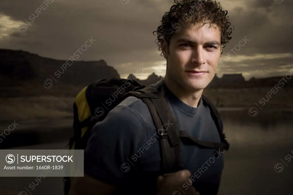 Portrait of a young man carrying a backpack