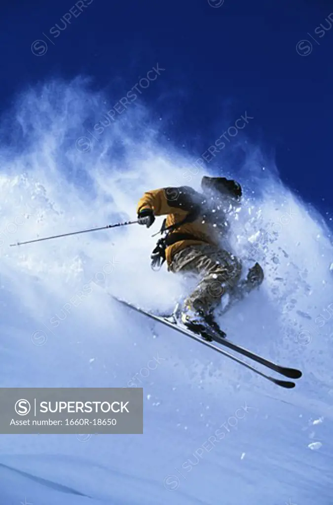 Downhill skier skiing on mountain