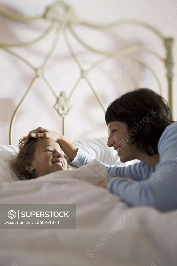 High angle view of a mother and a daughter looking at each other