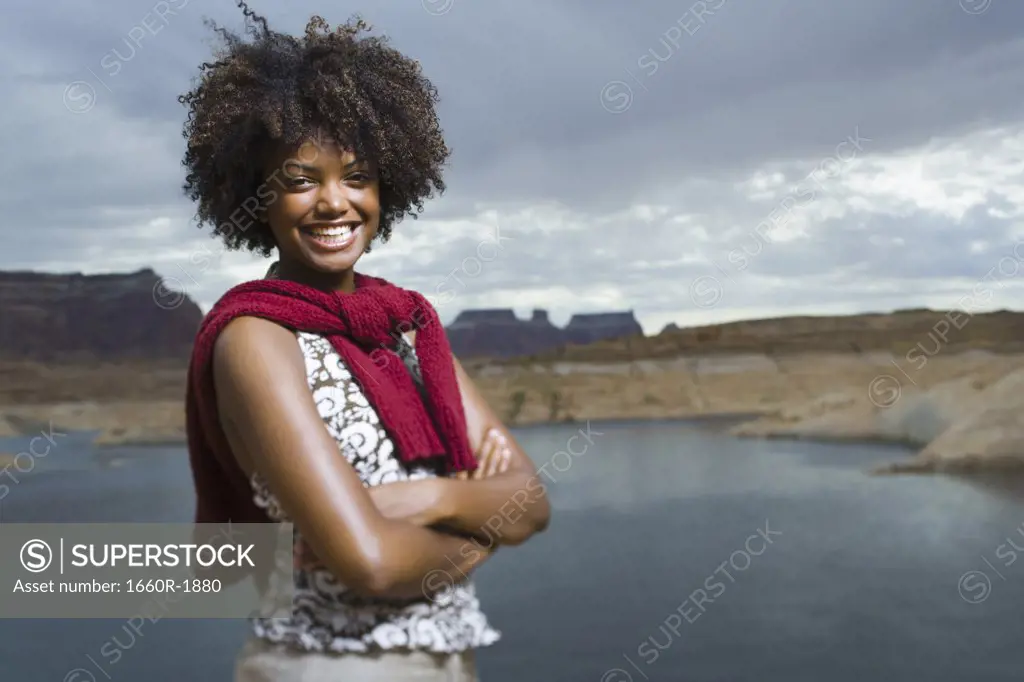 Portrait of a young woman standing on a lakeside