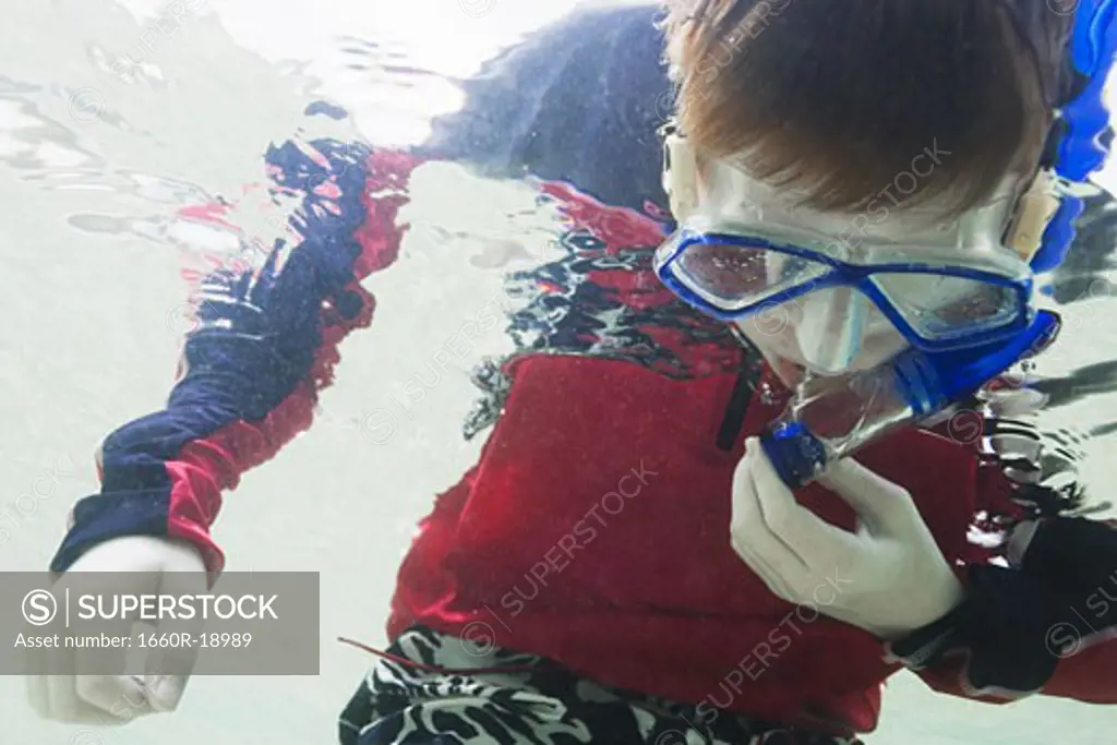 Boy underwater with goggles and snorkel