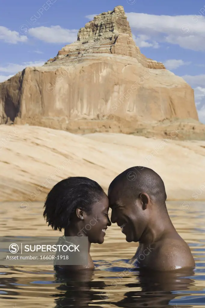 Profile of a young couple standing in a lake
