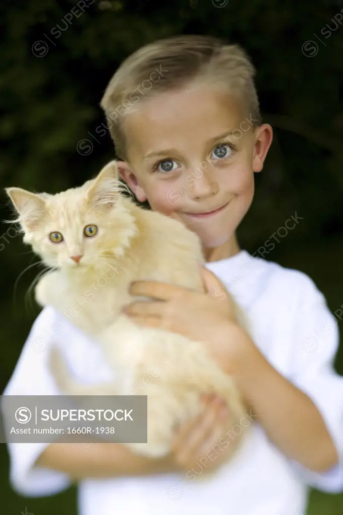 Close-up of a boy carrying his cat