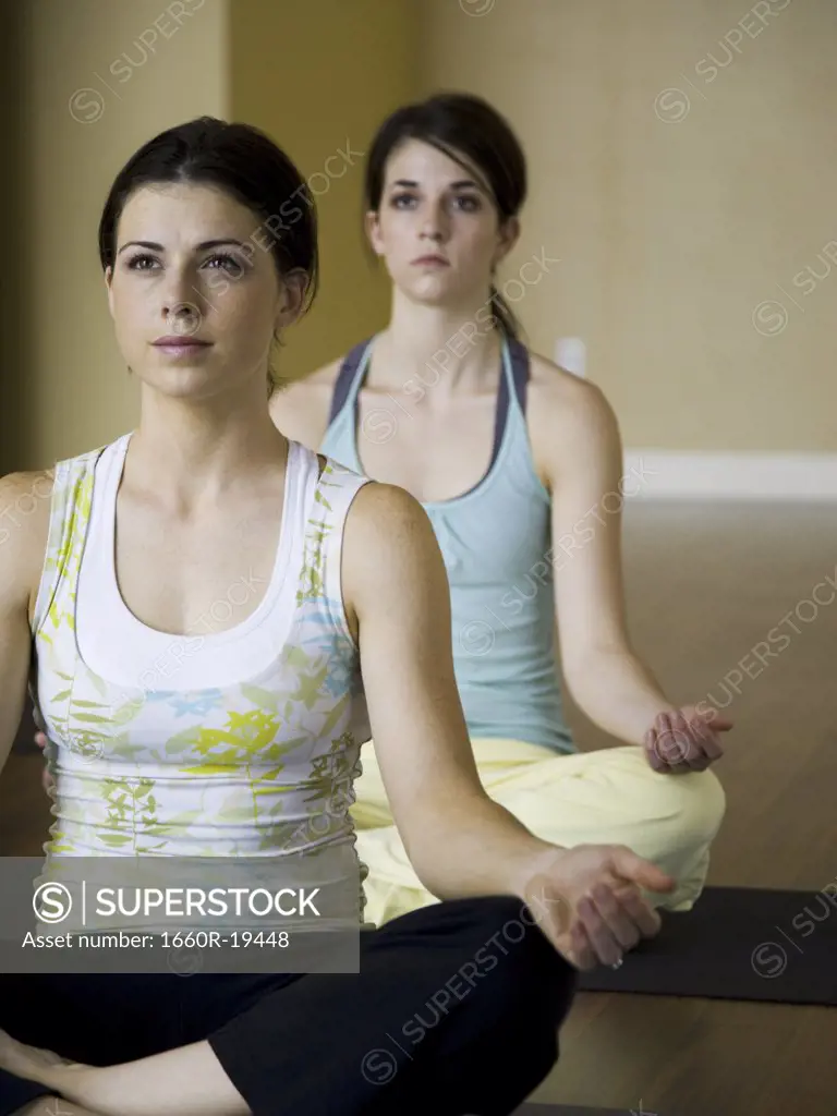 Two women doing yoga