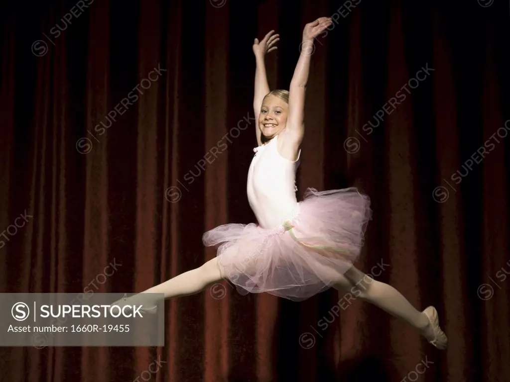 Ballerina girl leaping and smiling