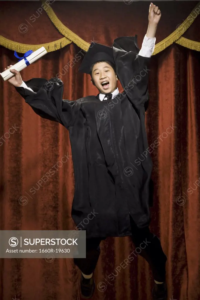 Boy graduate with mortar board and diploma smiling with braces and cheering