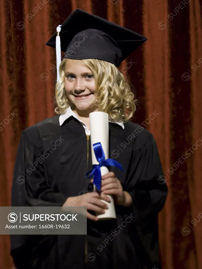 Girl graduate with mortar board and diploma smiling