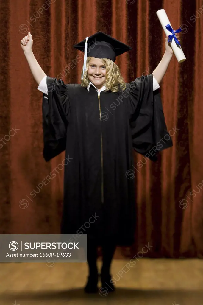 Girl graduate with mortar board and diploma smiling and cheering