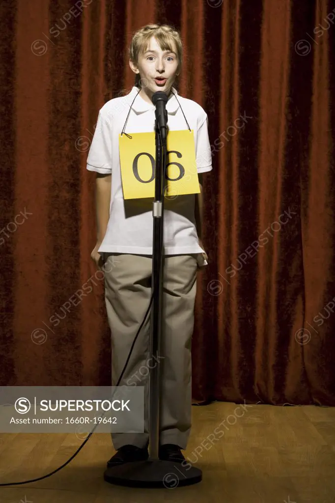 Girl contestant standing at microphone speaking