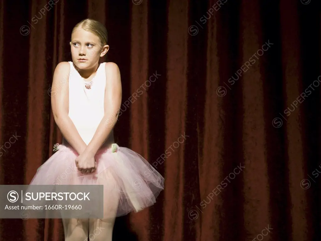 Ballerina girl with hands clasped nervously